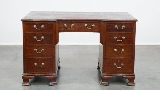 Image 1 of Luxurious and antique English wooden desk from the late 19th century with a leather top and a curved front.