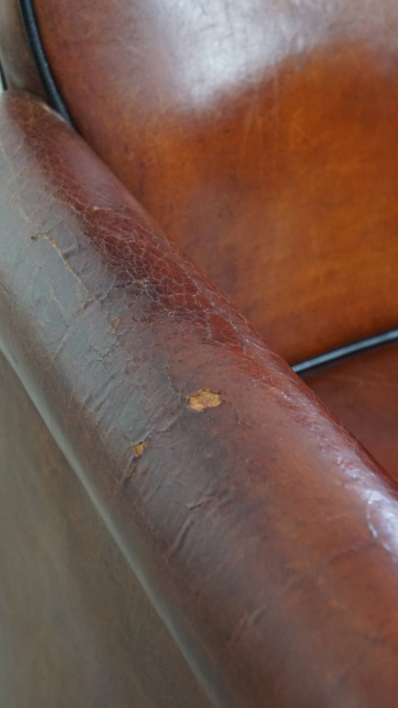 Image 1 of 6 x Vintage sheepskin dining chair with black piping on wheels