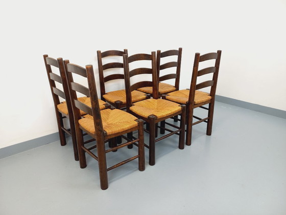 Image 1 of Set van 6 vintage brutalistische stoelen van Georges Robert, gemaakt van hout en stro, uit de jaren 50 en 60.