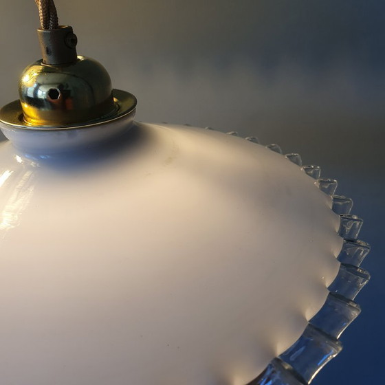 Image 1 of 2 vintage hanglampen van wit opaline glas met een transparante sierrand.