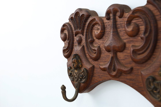 Image 1 of Antique Carved oak Wall mount coat rack with 3 brass angel hooks, France 1900s