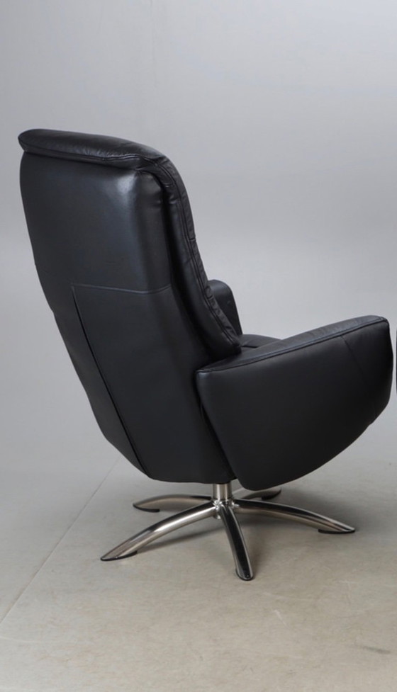 Image 1 of Modernist black leather armchair with a chrome X-frame base in a contemporary style, in good condition with minor signs of aging