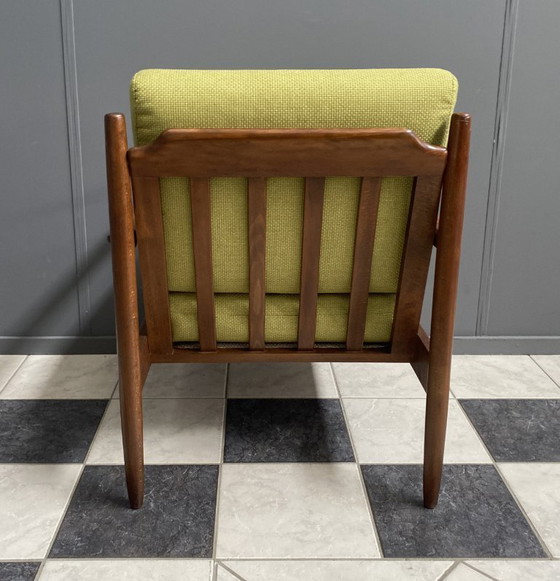 Image 1 of Gele stoffen en houten relaxstoel uit de jaren 60.
