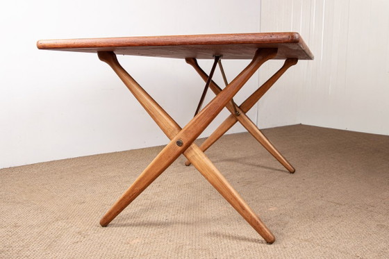 Image 1 of Deense eettafel van massief teak en beukenhout met messing, model AT 303, ontworpen door Hans Wegner voor Andreas Tuck in 1960.