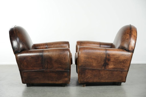 2 comode poltrone in pelle di pecora dal design Art Déco