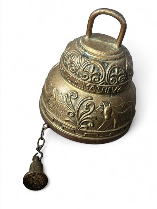 copper monastery bell with a religious ornament in relief.