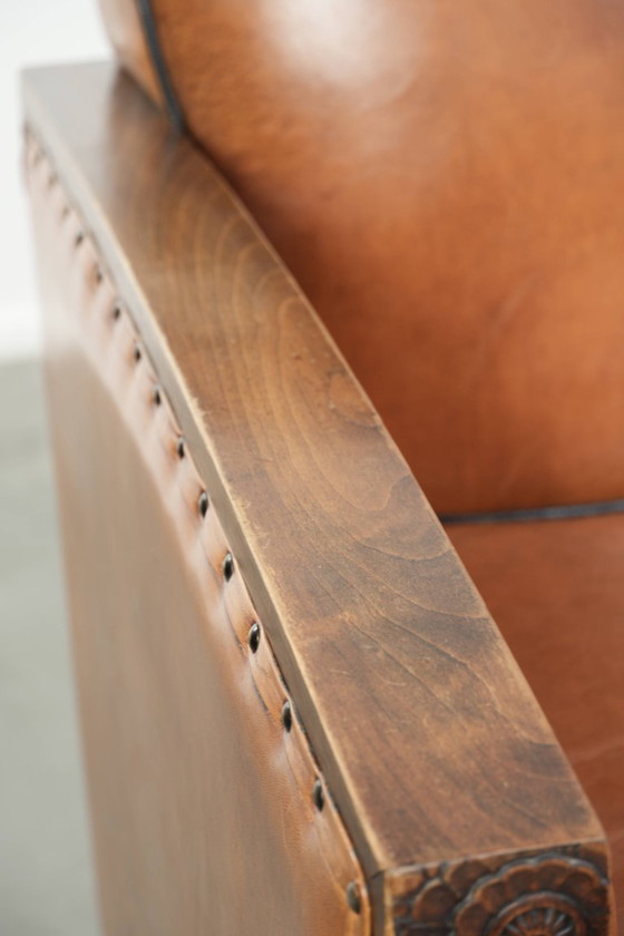 Image 1 of 2 x Prachtige schapenleren Art Deco fauteuil met mooi houtsnijwerk en zwarte biezen
