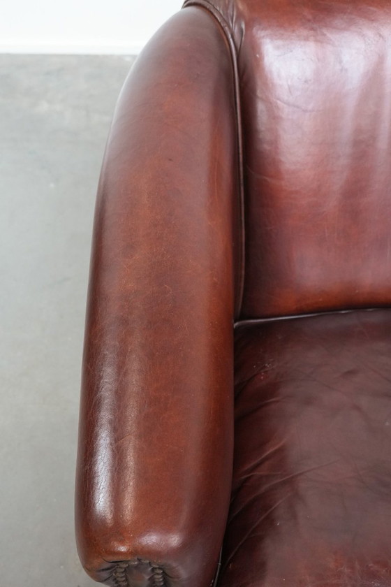 Image 1 of Vintage clubfauteuil gemaakt van schapenleer met siernagels
