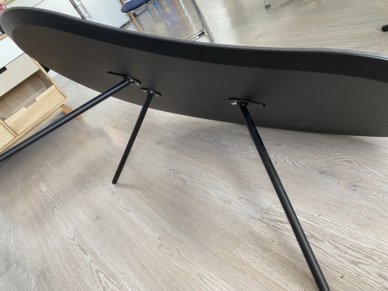 Image 1 of Hulshoff coffee table. Ceramic top with three metal legs. Kidney-shaped. Dimensions 76x120cm. As good as new.