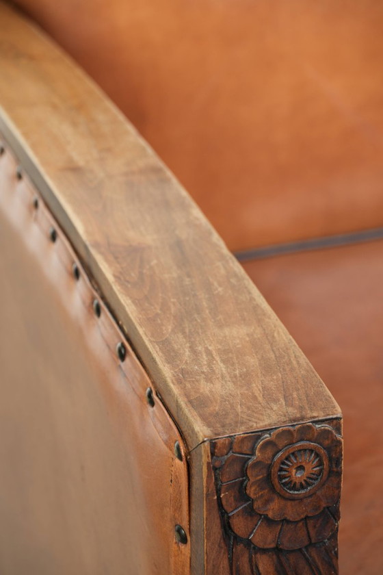 Image 1 of Schapenleren art Deco fauteuil met mooi houtsnijwerk en zwarte biezen