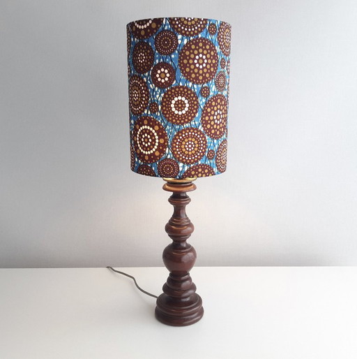 Turned wooden vintage lamp base with handmade lampshade of African wax fabric