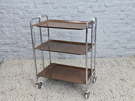Vintage Foldable and Mobile Chrome Steel 3 Faux Wood Layers ‘Dinett’ Serving Trolley by Gerlinol, Germany, 1970s. 