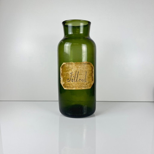 Large antique apothecary bottle in green blown glass