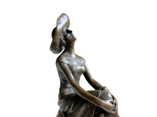 Elegant bronze sculpture woman with hat