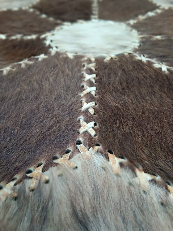 Image 1 of Vintage round coffee table with loose patchwork of cowhide