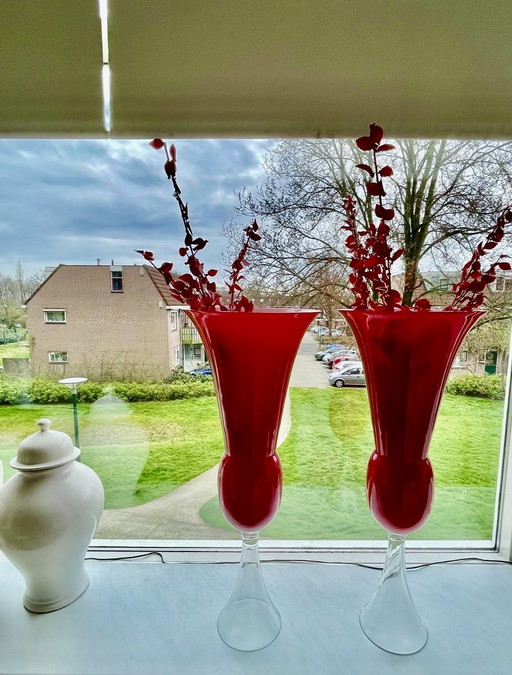 2 red and white vases with 5 decorative branches made of glass