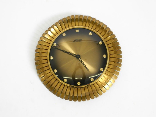 Beautiful original Mid Century Sunburst Atlanta Universe wall clock made of heavy brass with a mechanical seven-day movement