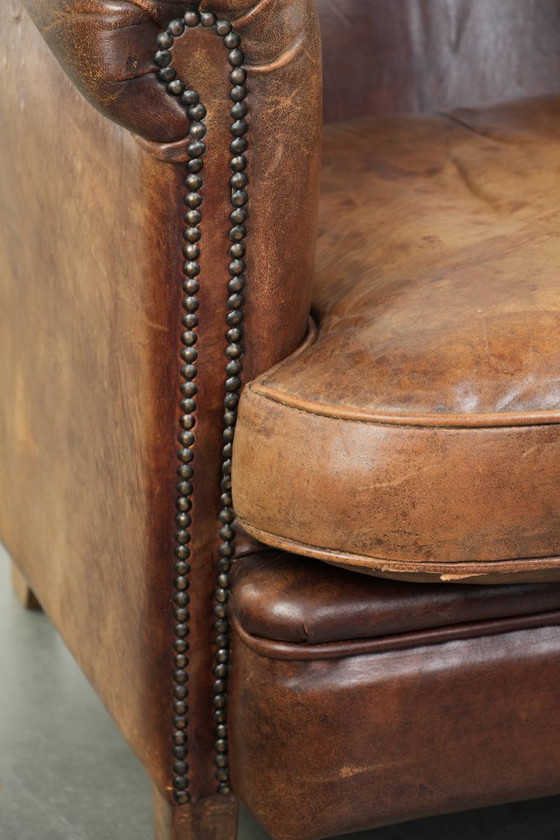 Image 1 of Stoere en begeerlijke vintage schapenleren clubfauteuil met een mooi patina en warme kleuren