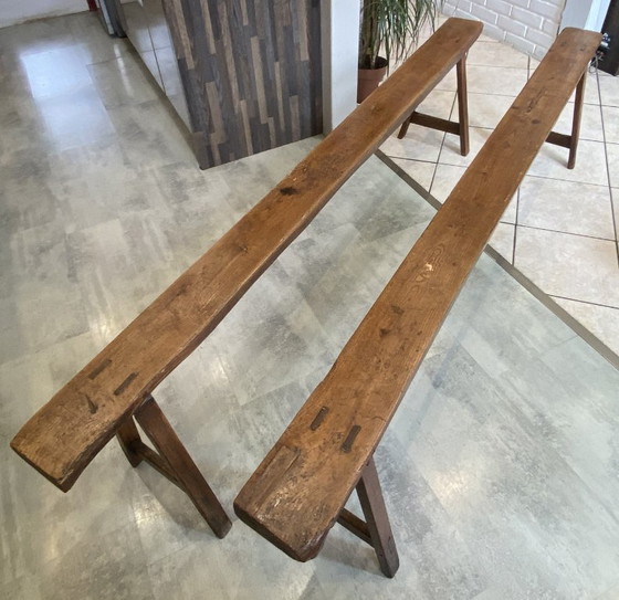 Image 1 of Twee massief eikenhouten boerenbanken van 214 cm voor een rustieke boerentafel uit de jaren 50.