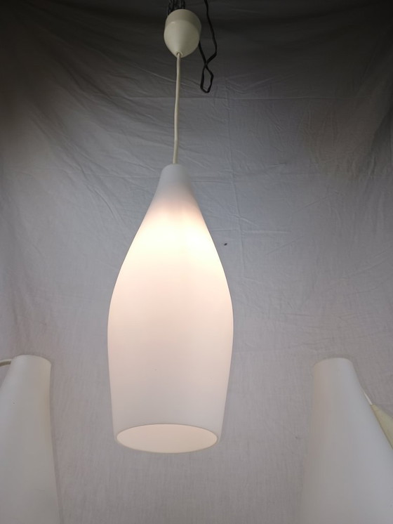 Image 1 of Elegant and timeless, this set of three original Holmegaard glass pendant lamps