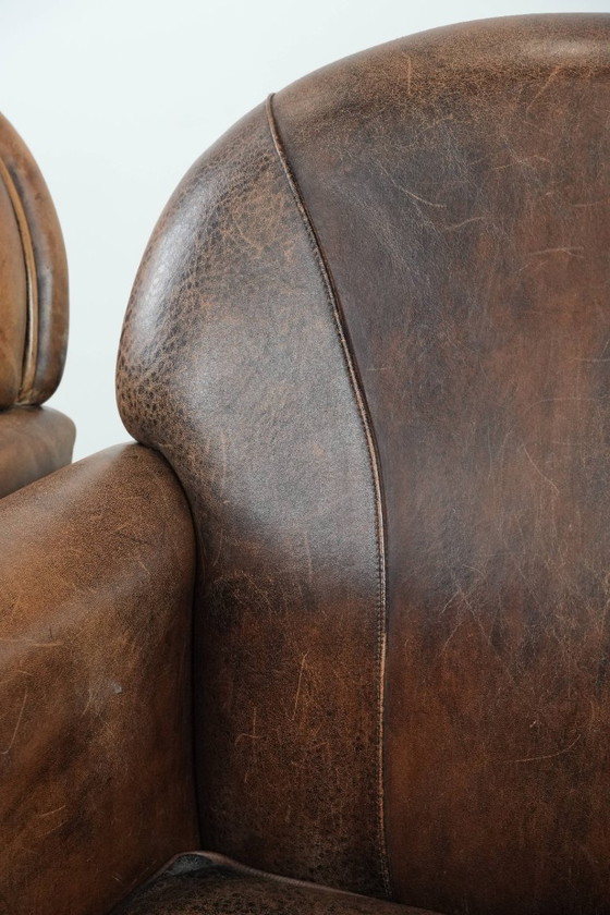 Image 1 of 2 x Vintage sheepskin armchair with warm colours and a characterful appearance