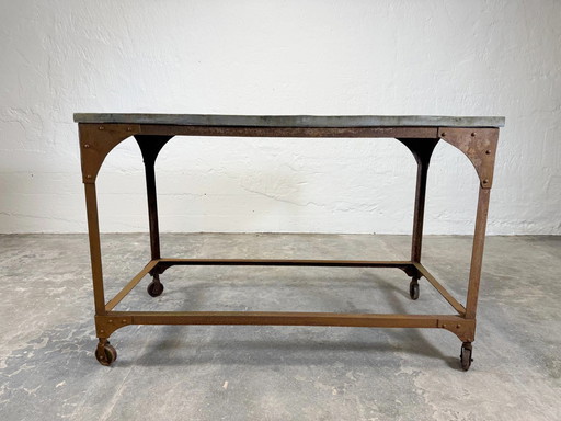 Mesa industrial vintage con tablero de piedra.