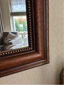 Specchio con cornice in legno pregiato e bordo sfaccettato lucido