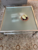 Glazen salontafel in roestvrijstalen frame