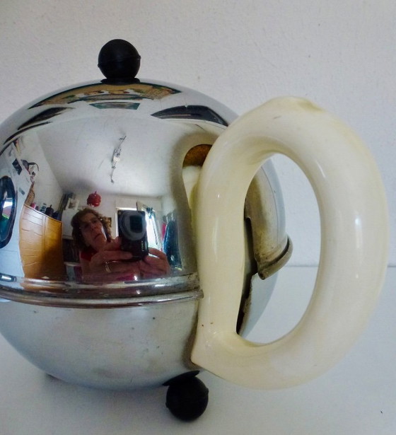 Image 1 of Ceramic Teapot with thermal Chrome casing which keeps the contents hot (or cold).