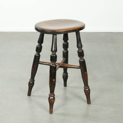 Antique English Windsor stool from the early 19th century with a unique oval shape