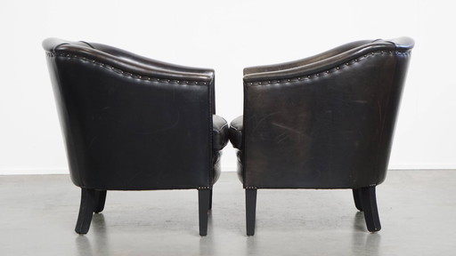  Set aus 2 dezenten schwarz/grauen Clubsesseln aus Schafsleder