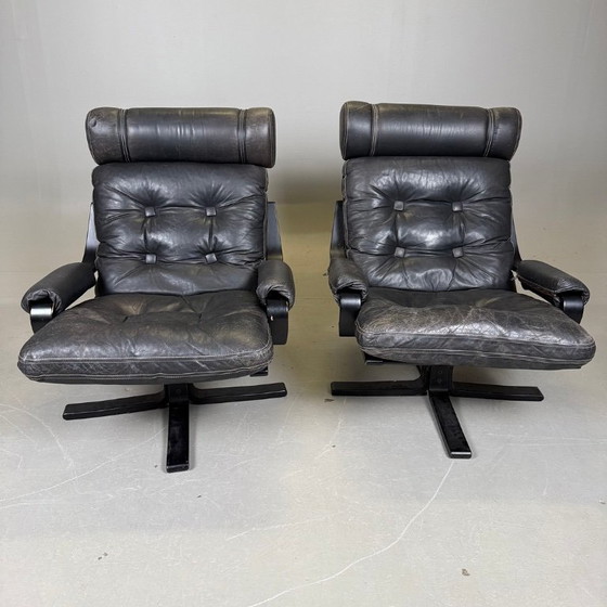 Image 1 of Pair of black leather, metal and wood Mid-Century Modern spinning armchairs in good condition with small signs of aging, 2 items