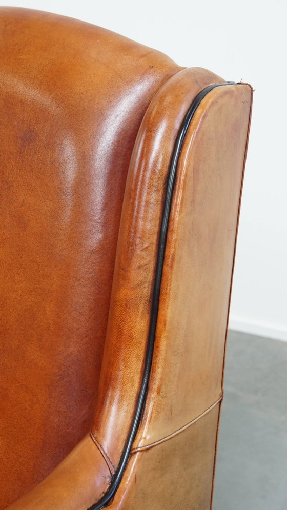 Image 1 of Schapenleren armchair met hoge rug en zwarte biezen 