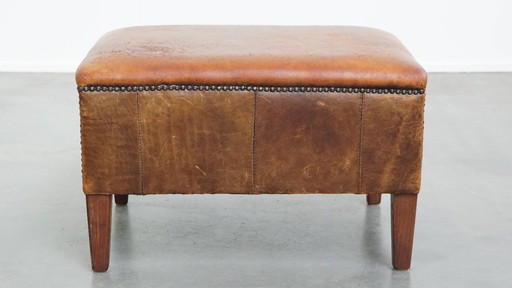 Hocker vintage en cuir de mouton