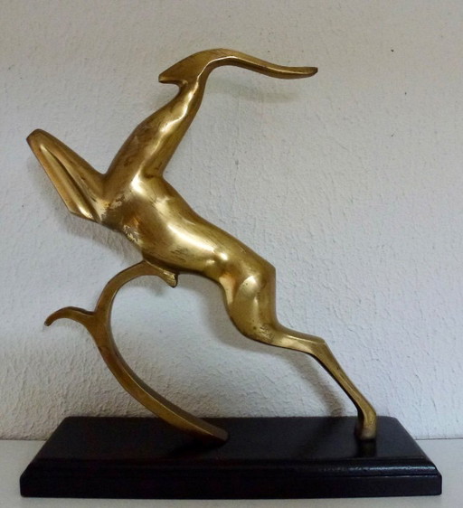 Beautiful brass gazelle on a lacquered wooden base.