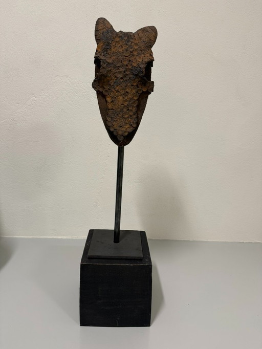 Decorative clay horse head on steel base