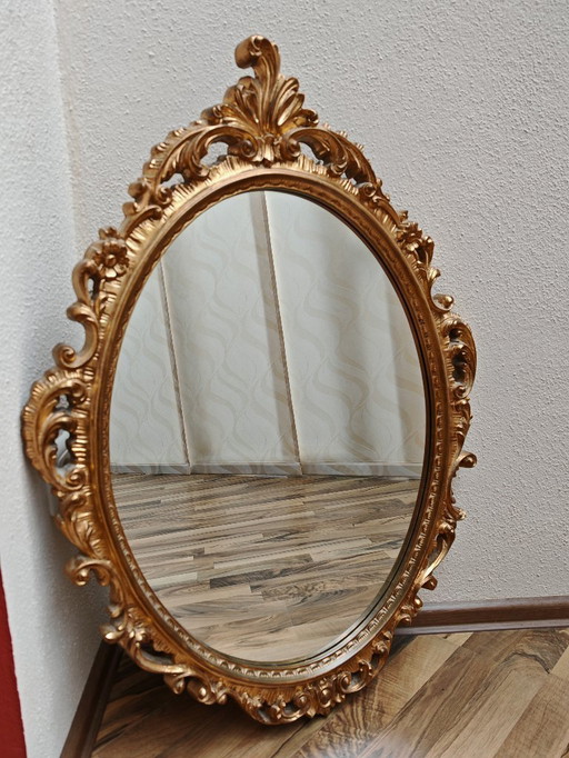 Oval mirror with golden wooden frame from an estate