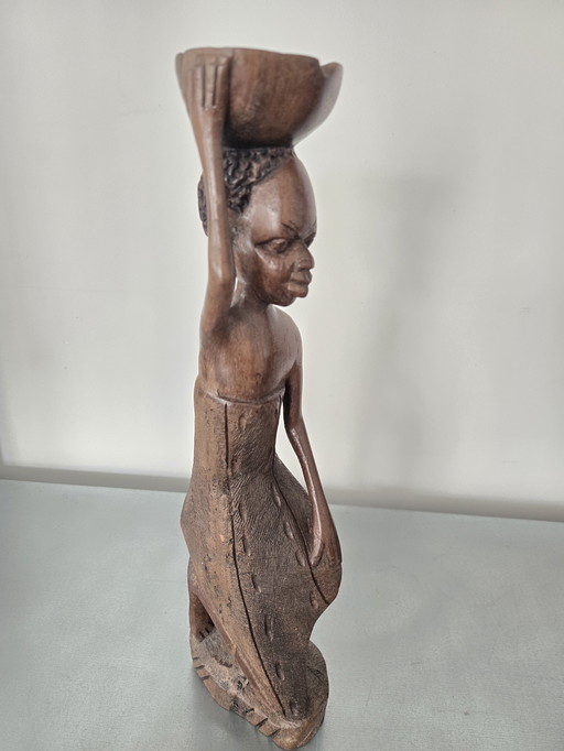 African statue of a woman with a bowl