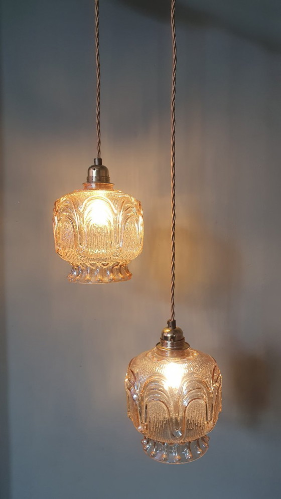 Image 1 of Set of 2 Vintage textured rose / amber tinted pendant lamps - mid-century design.