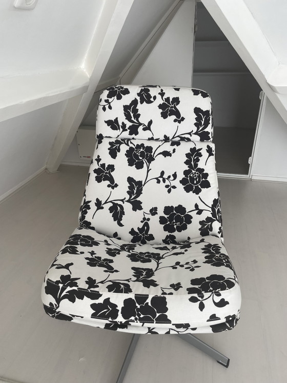 Image 1 of Black and white floral armchair with footstool