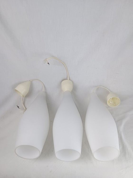 Image 1 of Elegant and timeless, this set of three original Holmegaard glass pendant lamps