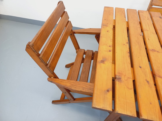 Image 1 of Vintage garden furniture consisting of a table with extensions and 4 wooden armchairs from the 60s