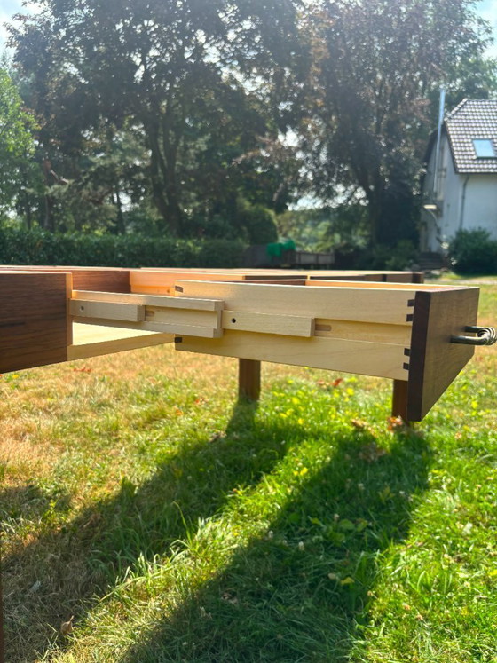 Image 1 of Dining table in American walnut and maple. Handcrafted solid wood extensions and drawers. Live edge for visual depth. Epoxy resi