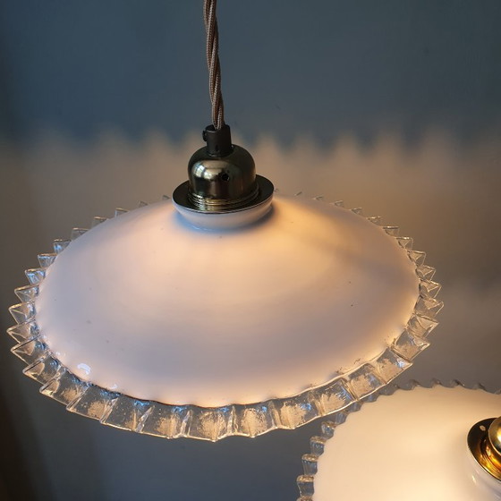 Image 1 of 2 vintage hanglampen van wit opaline glas met een transparante sierrand.