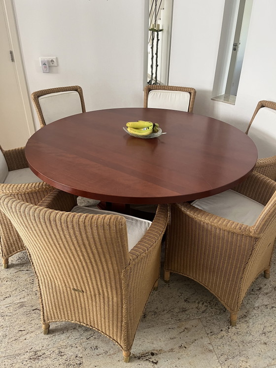 Image 1 of Solid cherry wood round table with beautiful matching Lloyd Loom chairs.