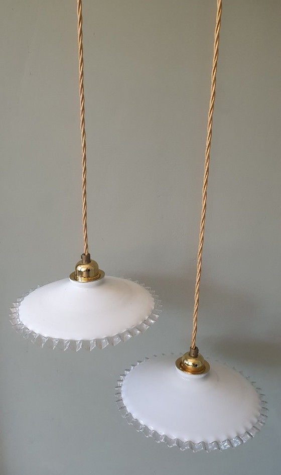 Image 1 of 2 vintage hanglampen van wit opaline glas met een transparante sierrand.