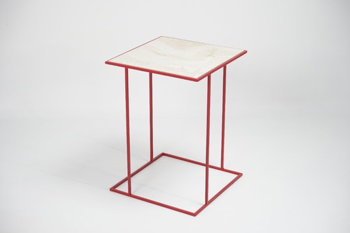 nest side table in travertine red