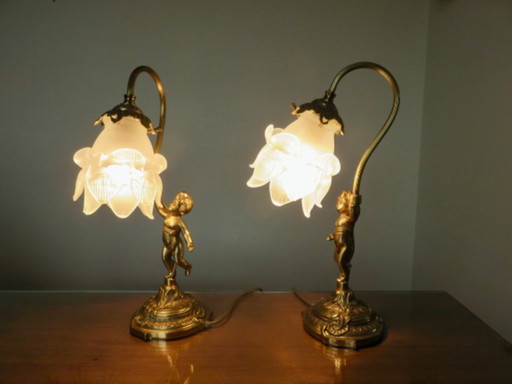pair of art nouveau "cherubs" bronze and frosted glass lamps