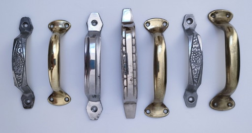 sette maniglie Art Déco in argento e ottone