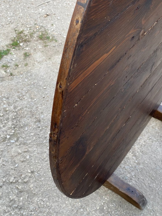 Image 1 of antique folding round winemaker's target table with tilting top